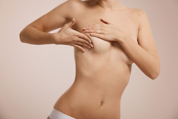 Woman checking her breast for breast cancer