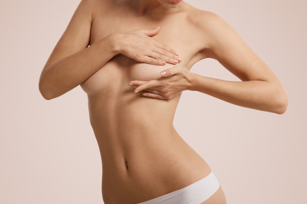 Woman checking her breast for breast cancer