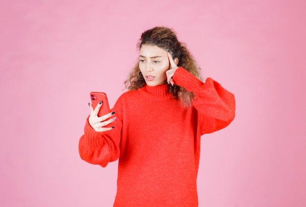 woman checking her new messages and thinking.