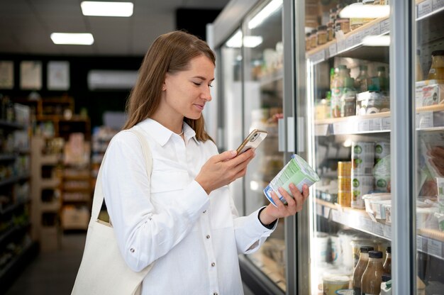 Woman checking label medium shot