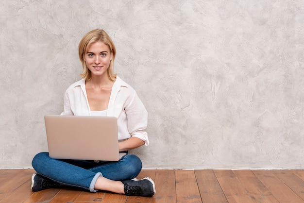 Woman checking laptop with copy space