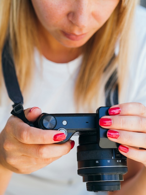 Женщина проверяет фотографии на камеру
