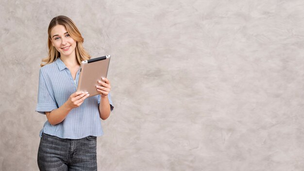 Woman checking tablet with copy space