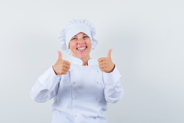 woman chef in white uniform showing double thumbs up and looking cheerful