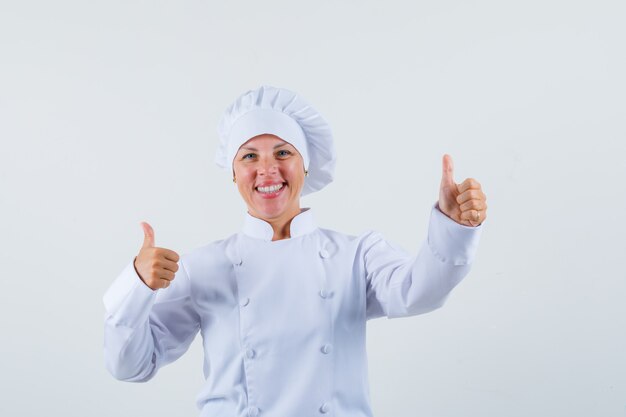 woman chef in white uniform showing thumb up and looking optimistic