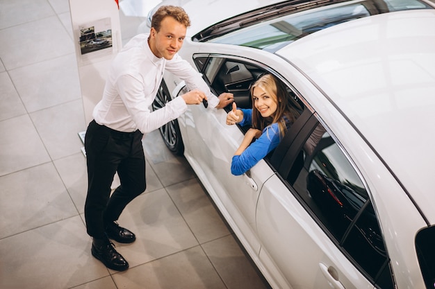Free photo woman choosing a car in a car showroom