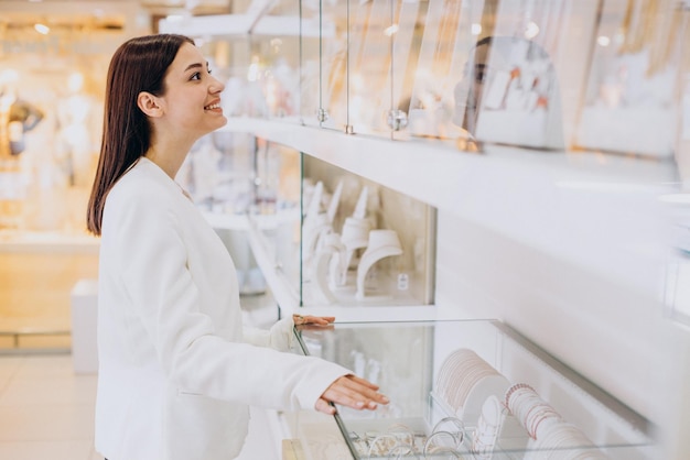 Woman choosing jewelry at jewelry shop