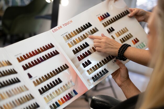 Woman choosing a new hair color from a catalog