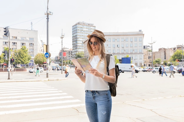 Free photo woman in the city looking at the map