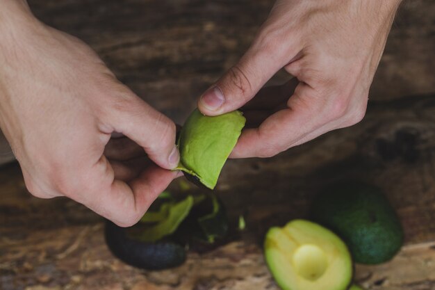 Woman cleaning avocado