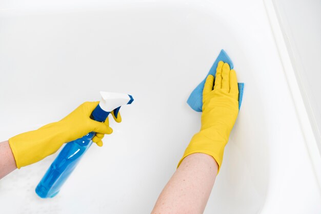 Woman cleaning bathtub