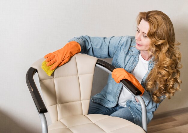 Woman cleaning chair