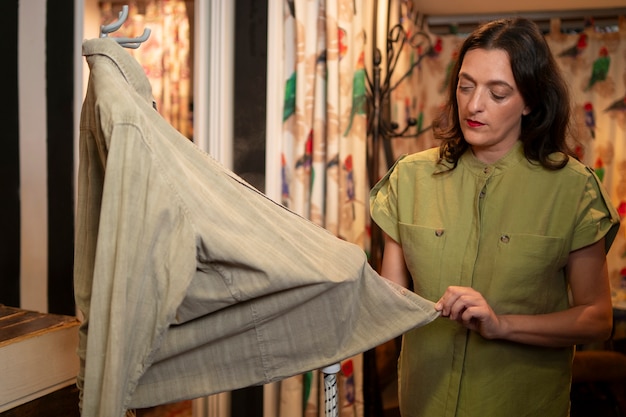 Free photo woman cleaning clothing in thrift store