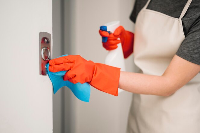 Woman cleaning elevator buttons