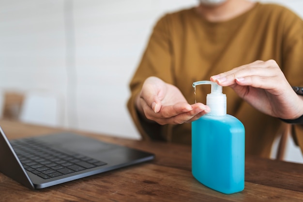 Woman cleaning hands with a hand sanitizer gel to prevent coronavirus contamination