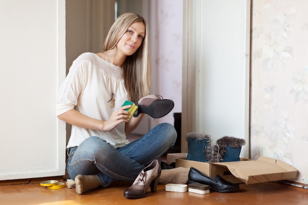 Woman cleans shoes