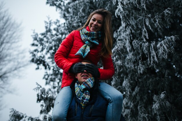 Woman climbed on the shoulders of a man