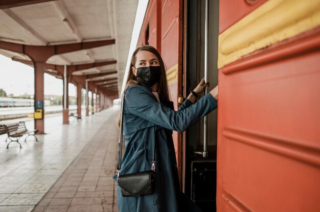 Woman climbs the stairs of the train