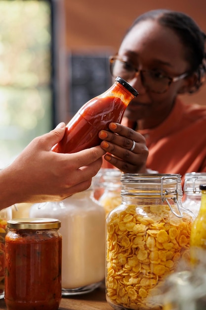 Free photo woman closely admires homemade sauce