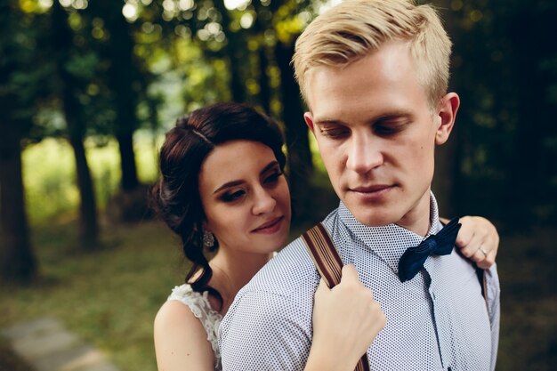 Woman clutching the straps of her husband