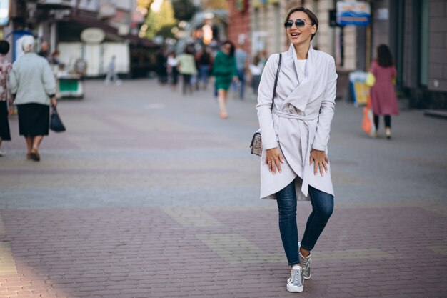 Woman in coat outside th street