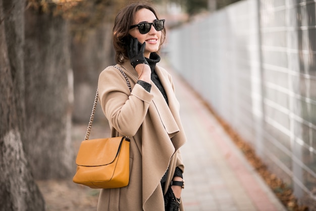 Woman in coat with phone