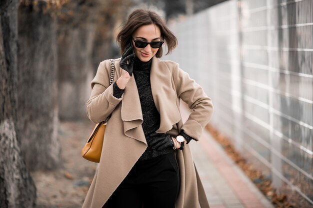 Woman in coat with phone