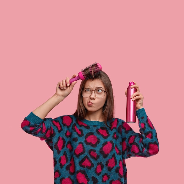 Woman in colorful sweater doing her hairstyle