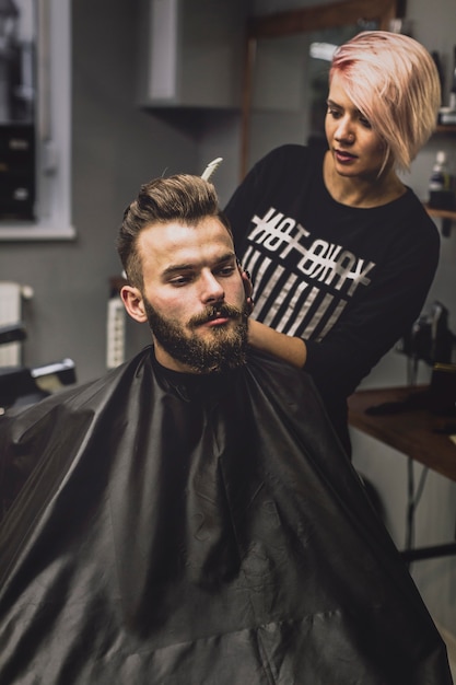 Woman combing stylish man