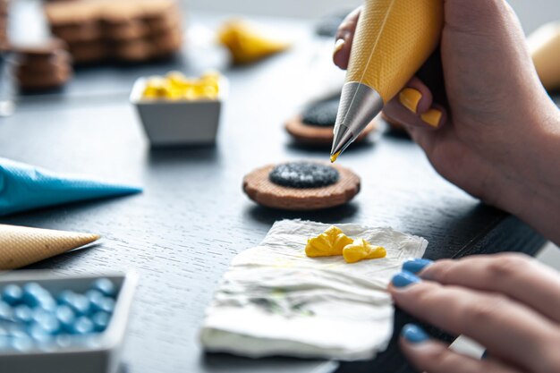 Woman confectioner making gingerbread sunflower gingerbread design