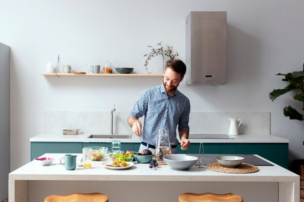 Woman cooking in a green kitchen