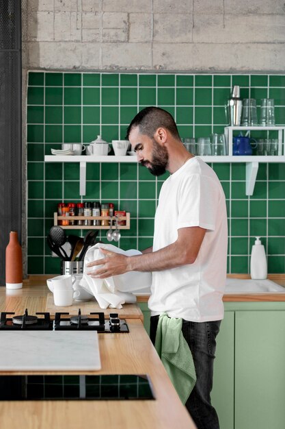 Woman cooking in a green kitchen