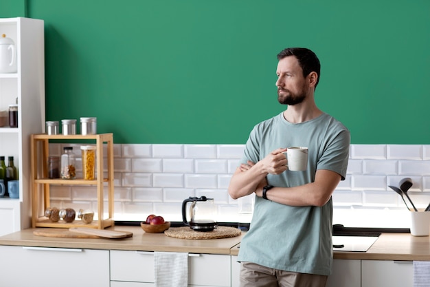 Woman cooking in a green kitchen