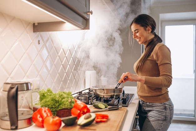 Woman cooking at kitchen