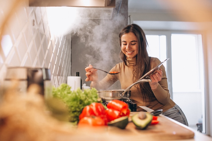 Free Photo woman cooking at kitchen