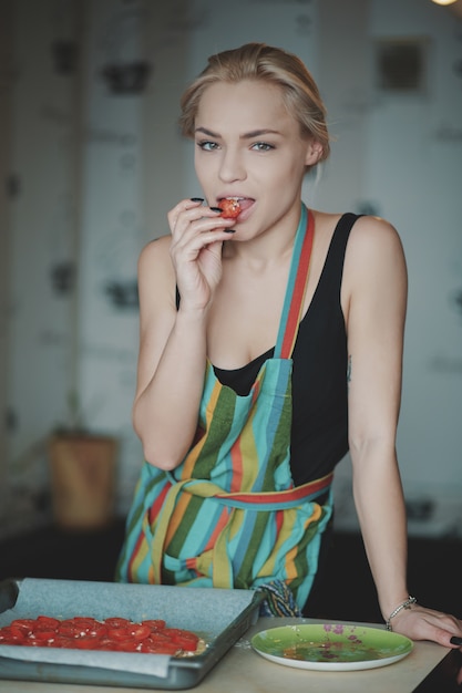 Woman cooking pizza at kitchen