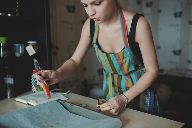 Woman cooking pizza at kitchen