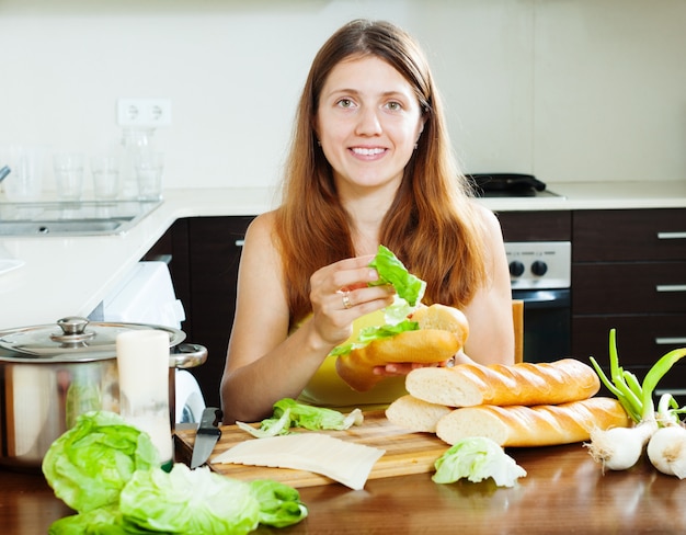 Woman cooking sandwiches with cheese and vegetables