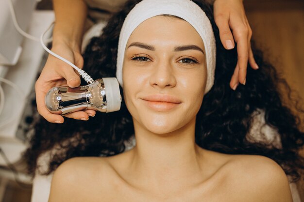 Woman at cosmetologist making beauty procedures