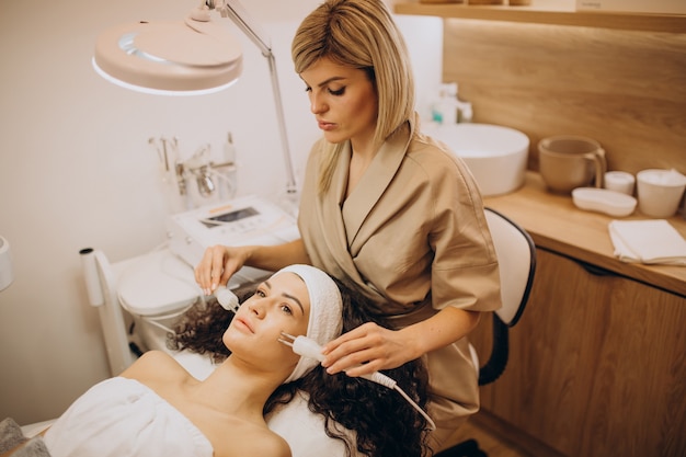 Woman at cosmetologist making beauty procedures