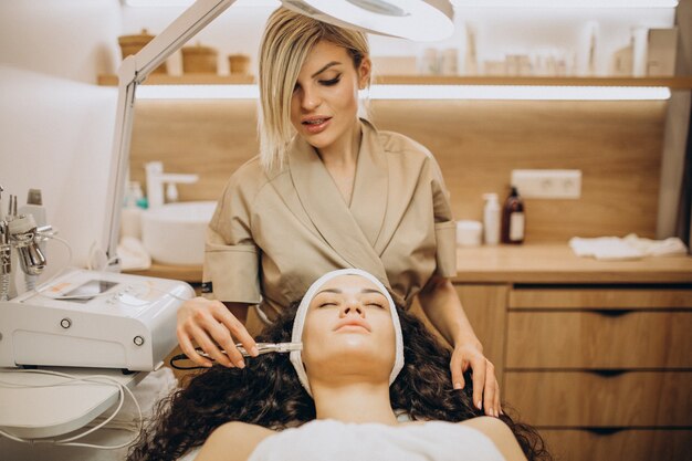 Woman at cosmetologist making beauty procedures