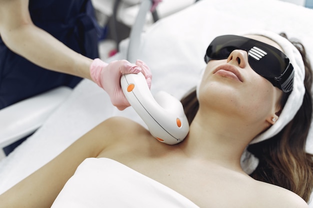 Woman in cosmetology studio on laser hair removal