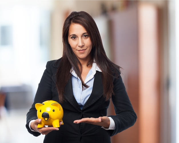 Free photo woman in costume pointing a piggy bank