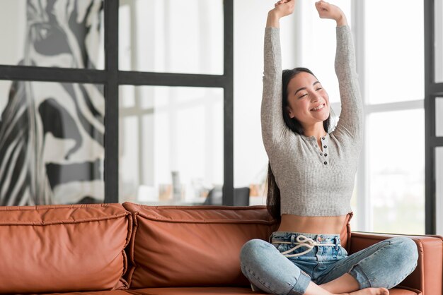 Woman on couch stretching