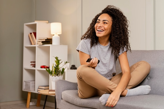 Woman on couch watching tv