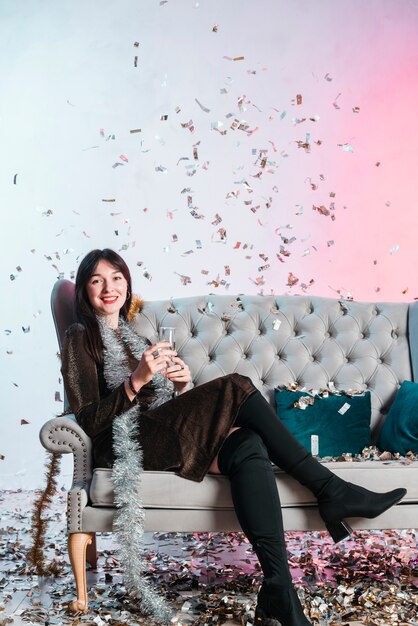 Woman on couch with champagne glass 