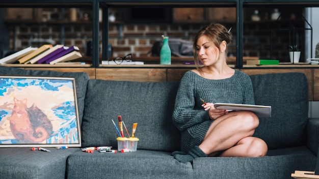 Woman on couch with painting