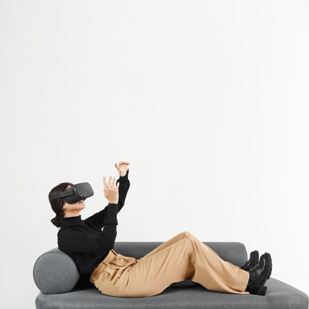Woman on couch with virtual reality headset