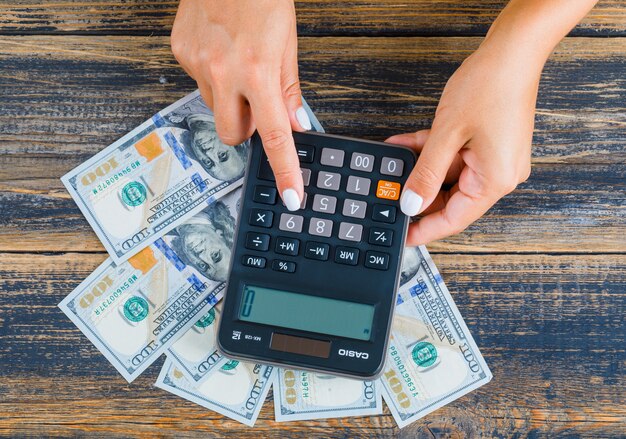 Woman counting money using calculator