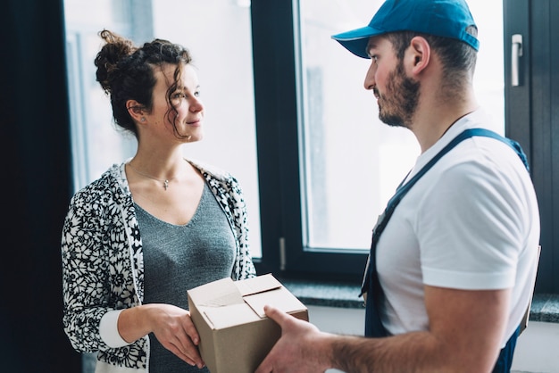 Woman and courier with parcel